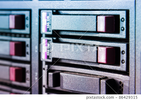 Row of hard drives serving as data storage inside server room 86429315