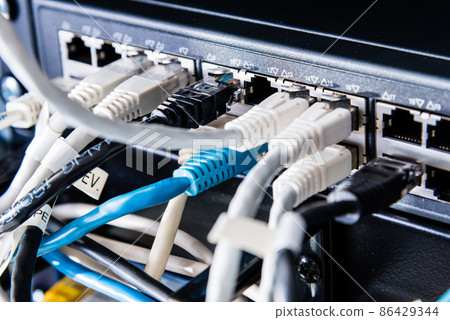 colorful patch cables connected to switch - high speed internet concept colorful patch cables connected to switch - high speed internet concept 86429344