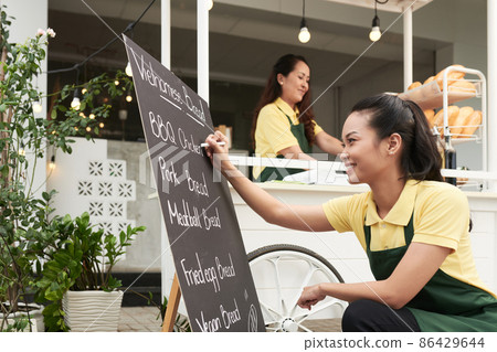 Woman Filling Board with Menu 86429644