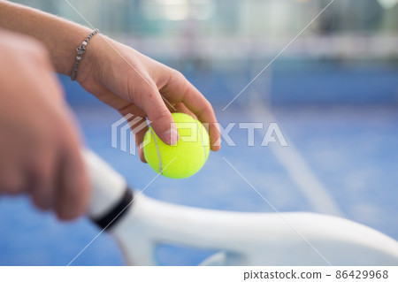 Hands of padel player holding racquet and ball Hands of padel player holding racquet and ball 86429968