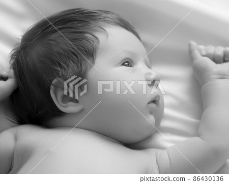 Nice newborn baby boy closeup portrait. Lying in 86430136