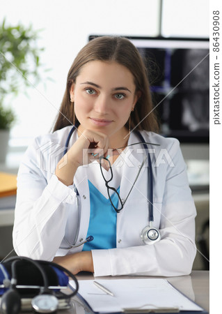 Portrait of woman doctor with glasses in her hands in clinic office 86430908
