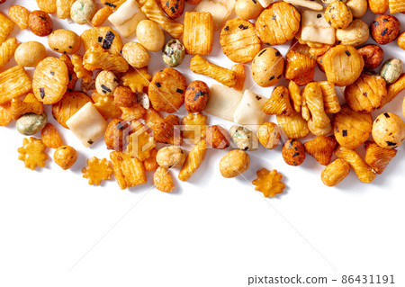Japanese rice crackers, scattered on a white background, overhead shot 86431191
