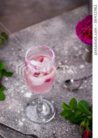 Pink cocktail with champagne and rose syrup 86432962