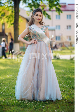 Beautiful schoolgirl in dress at the prom at school. Beautiful schoolgirl in dress at the prom at school. 86433001