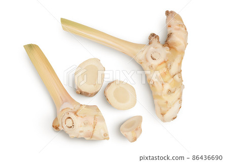 Fresh galangal root with slices isolated on white background with clipping path and full depth of field. Top view. Flat lay 86436690