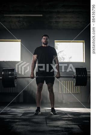 Athletic Bodybuilder Stand With Heavy Barbell . 86436796