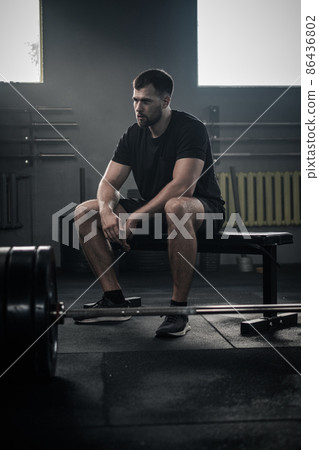 Serious Man Has Small Pause During Exercises . 86436802