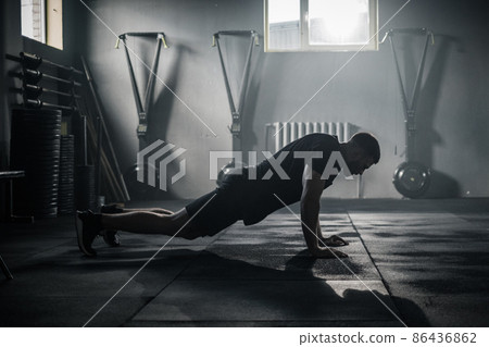 Sportsman Do Exercises at Big Dark Gym . 86436862