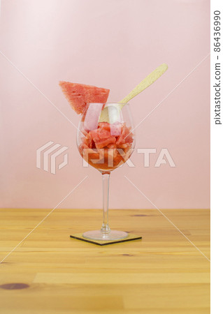 Sliced watermelon in a glass with a spoon Sliced watermelon in a glass with a spoon 86436990