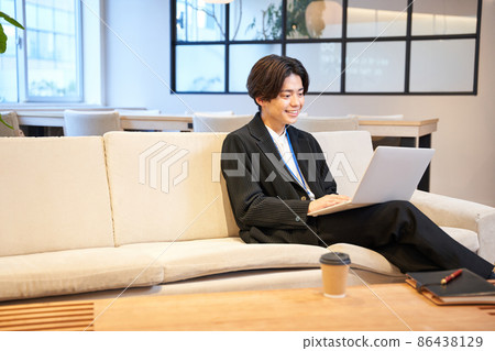 A young man working on a personal computer A young man working on a personal computer 86438129