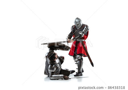 Full-length portrait of two medieval warriors, knights fighting isolated over white studio background Full-length portrait of two medieval warriors, knights fighting isolated over white studio background 86438318