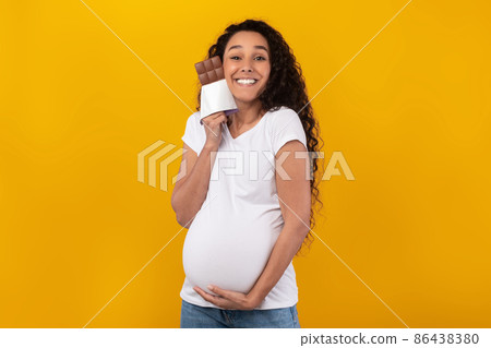 Funny Pregnant Latin Lady Holding Posing With Chocolate At Studio Funny Pregnant Latin Lady Holding Posing With Chocolate At Studio 86438380