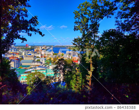 Aerial top view of Kyiv cityscape, Dnieper river and Podol historical district skyline from above, Kontraktova square with ferris wheel, city of Kiev, Ukraine. Aerial top view of Kyiv cityscape, Dnieper river and Podol historical district skyline from above, Kontraktova square with ferris wheel, city of Kiev, Ukraine. 86438388