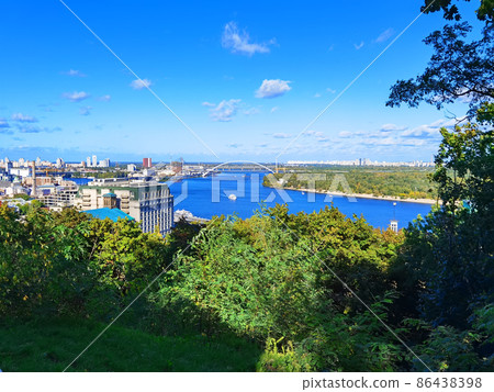 Aerial top view of Kyiv cityscape, Dnieper river and Podol historical district skyline from above, Kontraktova square with ferris wheel, city of Kiev, Ukraine. Aerial top view of Kyiv cityscape, Dnieper river and Podol historical district skyline from above, Kontraktova square with ferris wheel, city of Kiev, Ukraine. 86438398