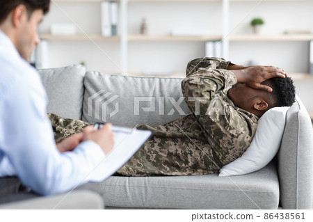 Downhearted black man soldier attending therapy session with psychologist Downhearted black man soldier attending therapy session with psychologist 86438561