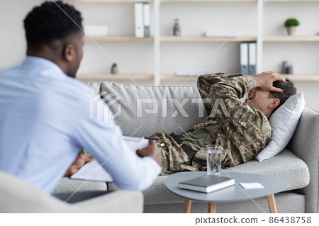 Emotional man soldier attending therapy session with psychiatrist Emotional man soldier attending therapy session with psychiatrist 86438758