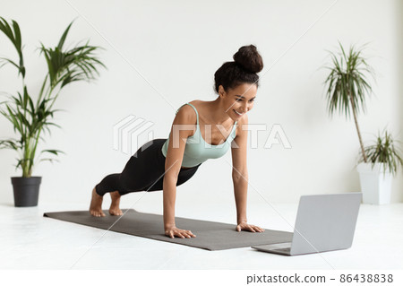 Remote Training. Sporty Lady Standing In Plank Position In Front Of Laptop Remote Training. Sporty Lady Standing In Plank Position In Front Of Laptop 86438838