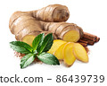 Giner root next to pile of cinnamon sticks,  mint leaves and ground cinnamon isolated 86439739
