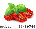 Dried or Sundried tomato halves with   basil isolated 86439746