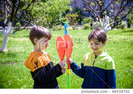 Two friends are playing tetherball swing ball game in summer camping. Two boy brother happy leisure healthy active time outdoors concept 86439782