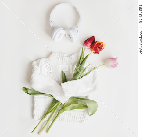creative trendy flatlay with knitted sweater and fresh tulips, top view. 86439891