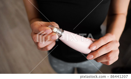 Vacuum blackhead remover in woman hand, cosmetic beauty procedure at home Vacuum blackhead remover in woman hand, cosmetic beauty procedure at home 86441207