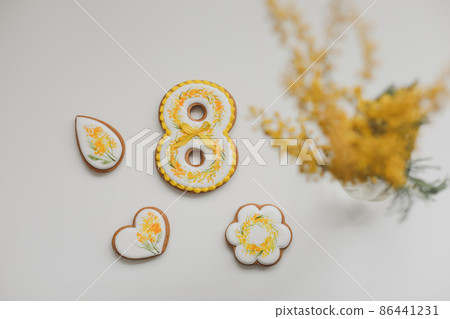 Women's Day, March 8, figure eight, gingerbread, flowers. Space for text. 86441231