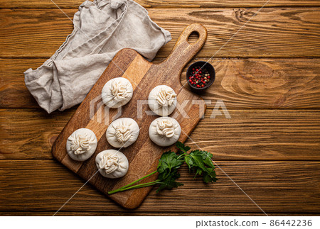 Raw freshly made Khinkali, traditional dish of Georgian Caucasian cuisine, dumplings 86442236