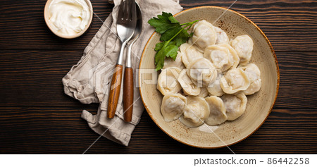 Pelmeni, traditional dish of Russian cuisine, boiled dumplings with minced meat Pelmeni, traditional dish of Russian cuisine, boiled dumplings with minced meat 86442258