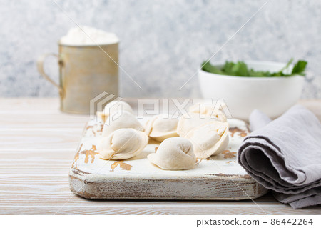 Raw uncooked pelmeni, traditional dish of Russian cuisine, dumplings with minced meat 86442264