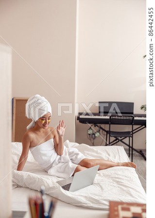 Asian young woman using laptop after shower at home 86442455