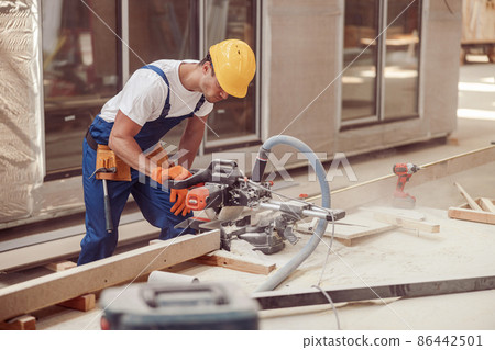 Male builder using wood cutting circular saw machine 86442501