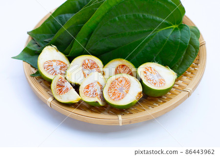Chewing betel nut, Betel nut with cal lime powder on betel leaves 86443962