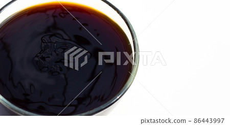 Oyster sauce in glass bowl on white background. Oyster sauce in glass bowl on white background. 86443997