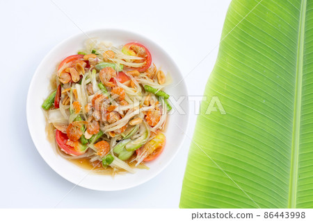 Dish of spicy papaya salad on white. Dish of spicy papaya salad on white. 86443998