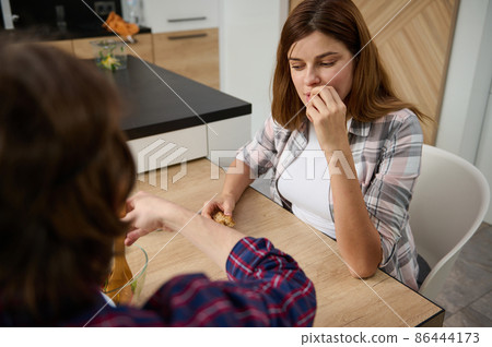 Caucasian loving couple having dinner together at home. Caucasian loving couple having dinner together at home. 86444173