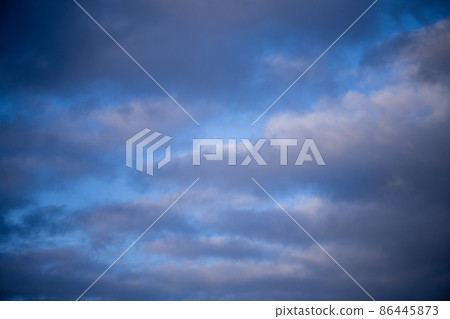 Blue sky shrouded in gray dark clouds Blue sky shrouded in gray dark clouds 86445873