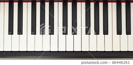 Piano and Electronic piano keyboard with black backgrounds. Closeup of black and white piano keys, copy space, banner Piano and Electronic piano keyboard with black backgrounds. Closeup of black and white piano keys, copy space, banner 86446261