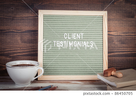 Client Testimonials. English text on a letter Board. Stationery on a wooden table 86450705