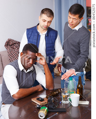 Offended man during quarrel with friends 86452075