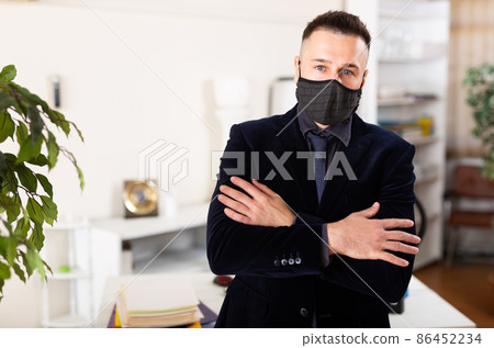 Business in mask standing in his office Business in mask standing in his office 86452234