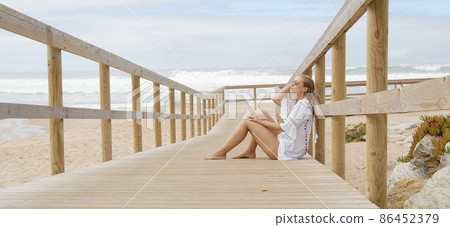 Sexy girl poses for the camera - happy girl on summer vacation at the beach Sexy girl poses for the camera - happy girl on summer vacation at the beach 86452379
