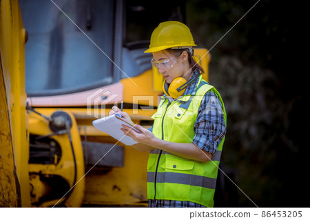 Portrait worker industry factory wear safety uniform factory drive a forklift car and control production work in factory area for another worker. 86453205
