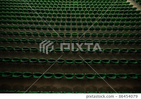 Empty stadium tribune with green seats. 86454079