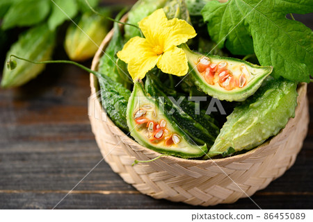 Small bitter gourd or bitter melon in bamboo basket on wooden background Small bitter gourd or bitter melon in bamboo basket on wooden background 86455089