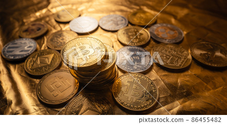 Cryptocurrency coin and bitcoin on golden background Cryptocurrency coin and bitcoin on golden background 86455482