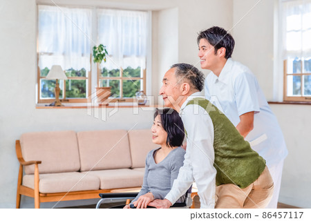 Rehabilitation Center A certified care worker and an elderly couple 86457117