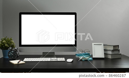 Mockup computer pc with white display, alarm clock, houseplant and picture frame on black table. Mockup computer pc with white display, alarm clock, houseplant and picture frame on black table. 86460287