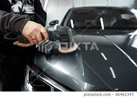 Car detailing. Male hands with orbital polisher in auto repair shop 86462345